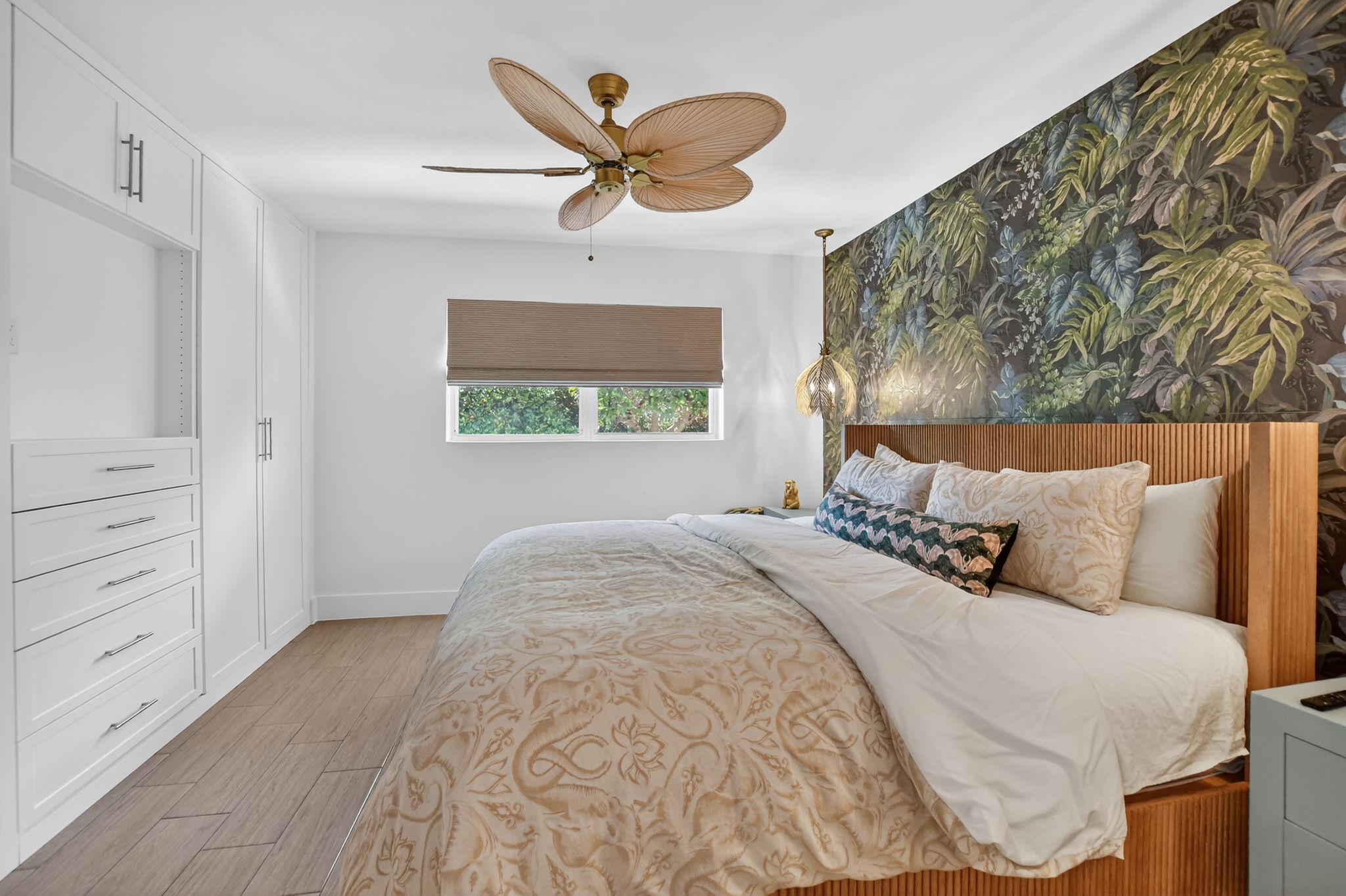 Bedroom with tropical leaf accent wall