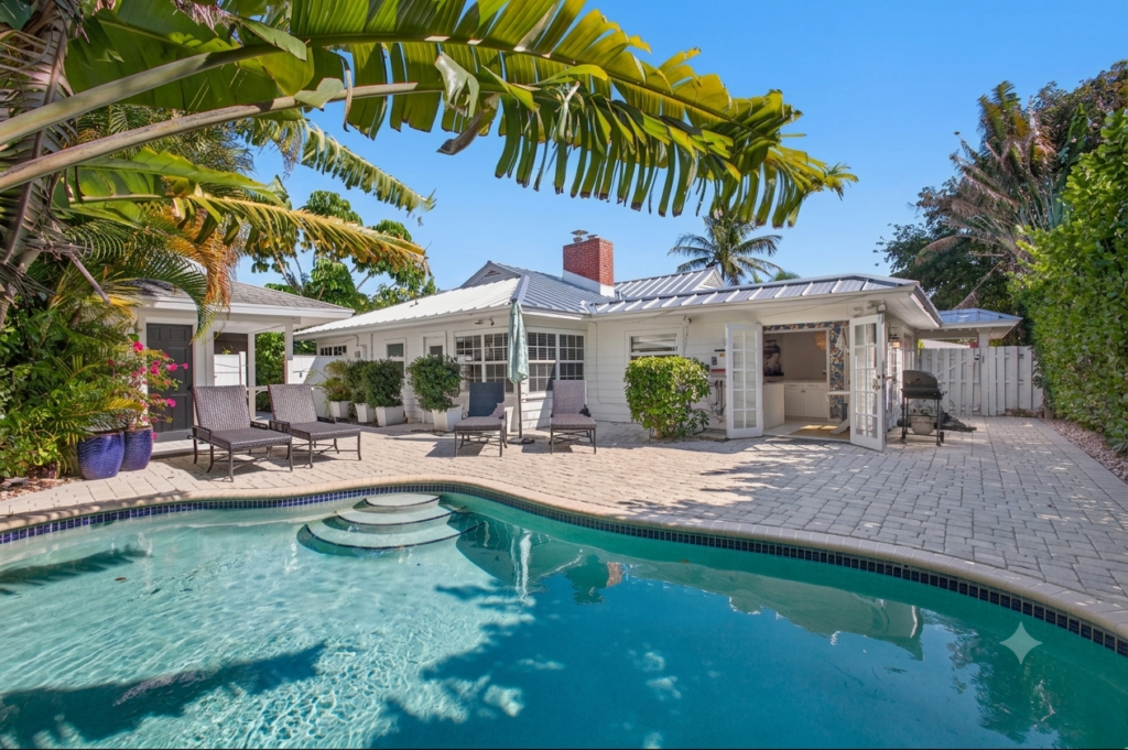 Private pool surrounded by palm trees at Palm Breeze Retreat, a vacation rental in West Palm Beach, Florida