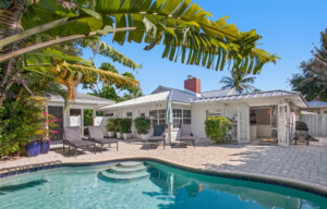 Private pool surrounded by palm trees at Palm Breeze Retreat, a vacation rental in West Palm Beach, Florida