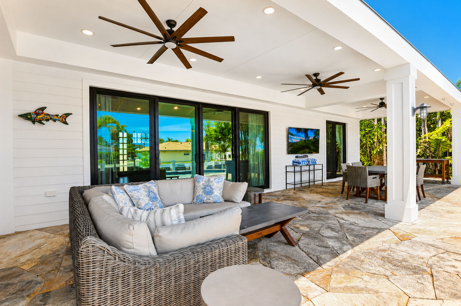 Covered patio with outdoor seating and ceiling fans