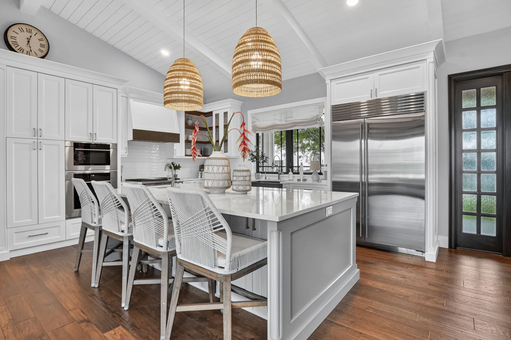 White kitchen with island and pendant lights